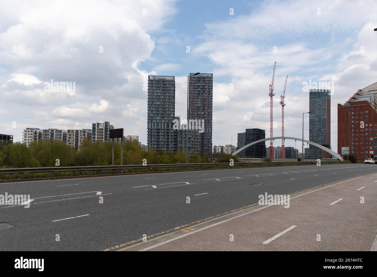 Waterden Road, Queen Elizabeth Olympic Park, Stratford, east London, with Olympic Park Avenue curved bridge and buildings in background. Stock Photo
