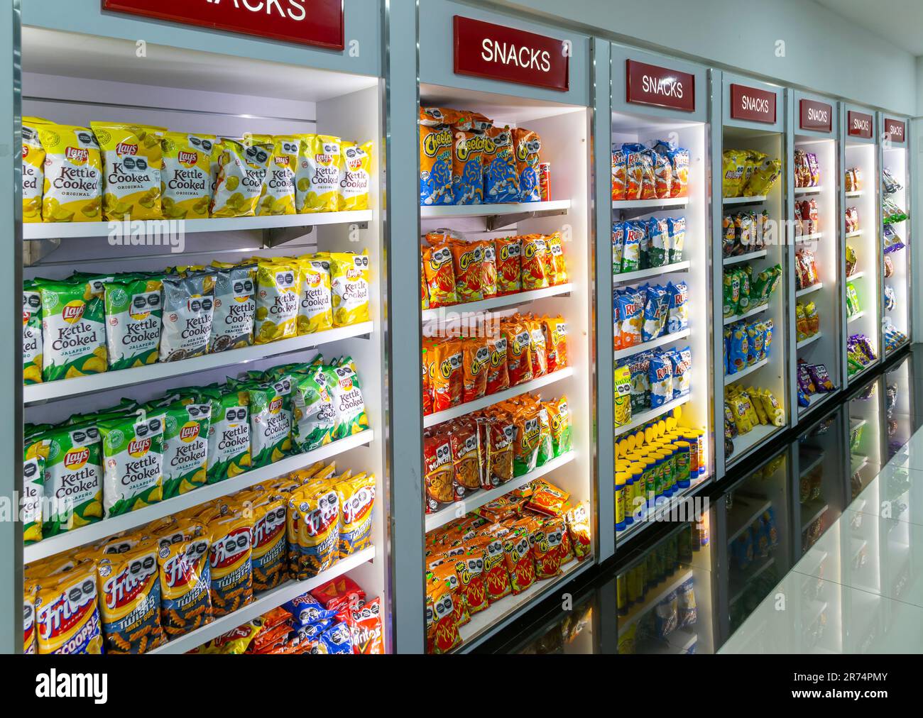Display rows in shop of packets of crips, bags of chips, potato and