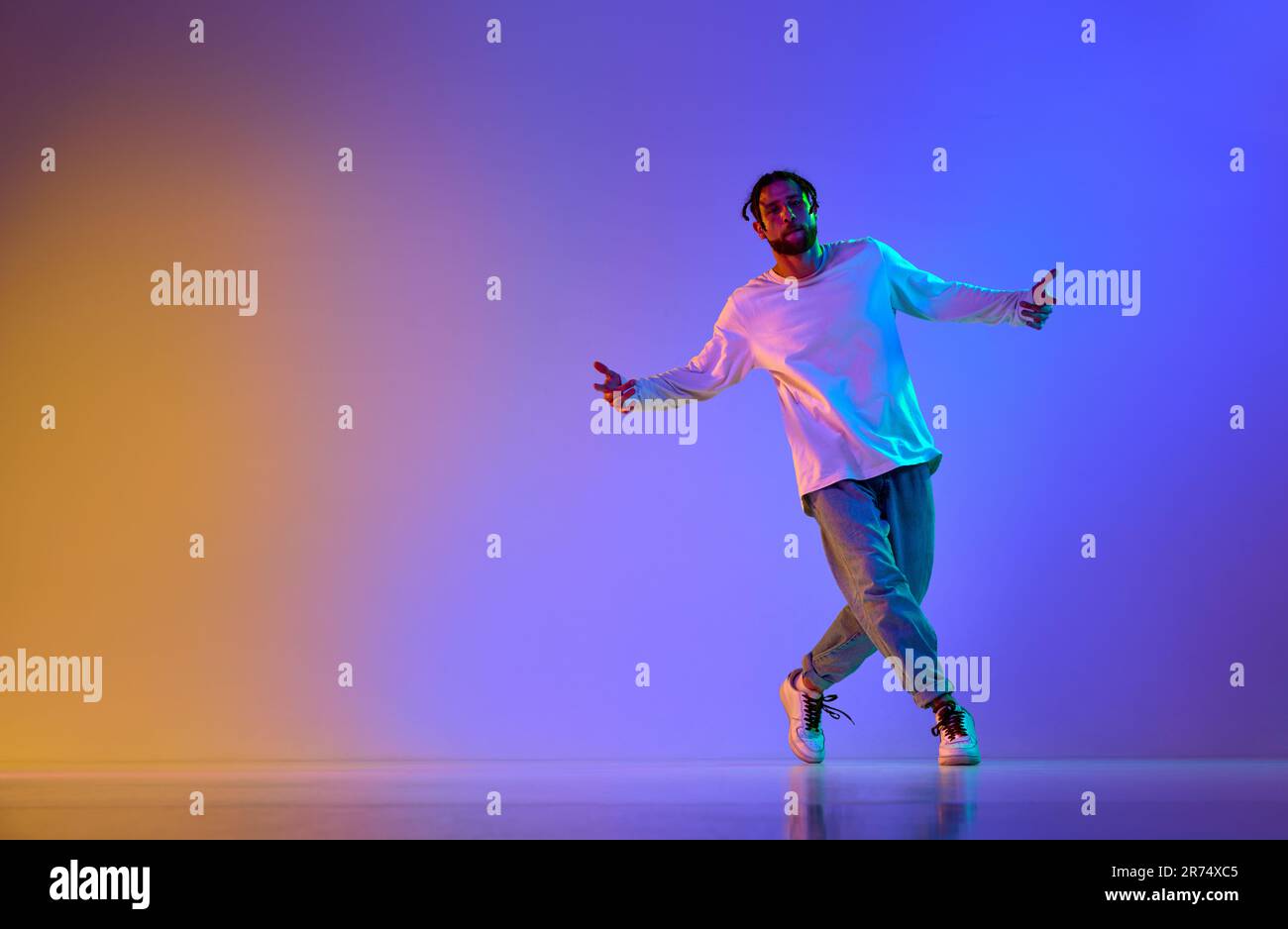 Dance show. Young guy dancing contemp, breakdance and hip-hop against ...