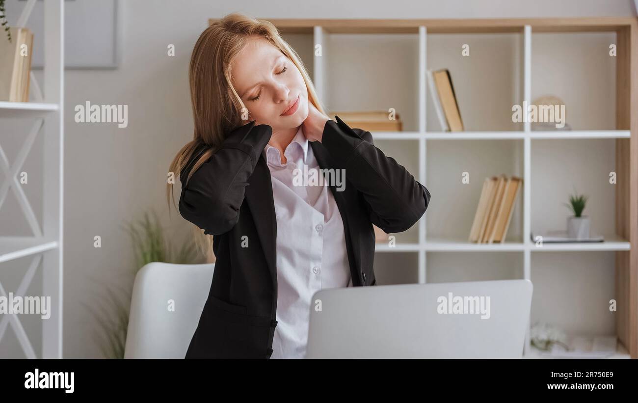 Neck exercise sitting work woman massaging spine Stock Photo - Alamy
