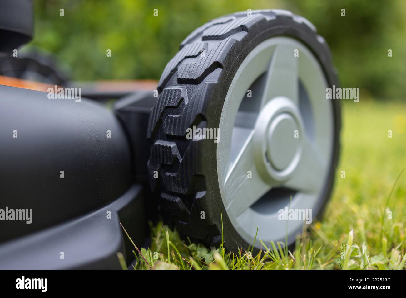 Lawn mower wheel front, detail, new battery lawn mower WORX NITRO WG749E - 40 V, lawn mowing, garden, Stock Photo