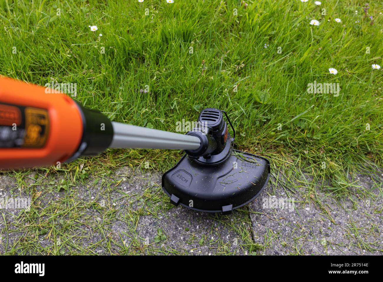 Cutting lawn edges with Black & Decker cordless lawn trimmer, lawn care, garden, Stock Photo