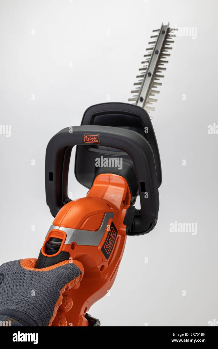 Hand holding Black Decker battery hedge trimmer 18V white background Stock Photo Alamy