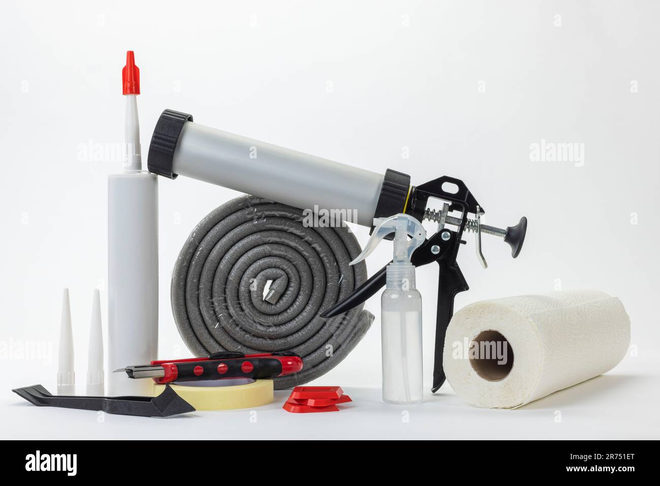 Cartridge press next to it silicone cartridge, tools and materials to renew silicone joints, white background, Stock Photo