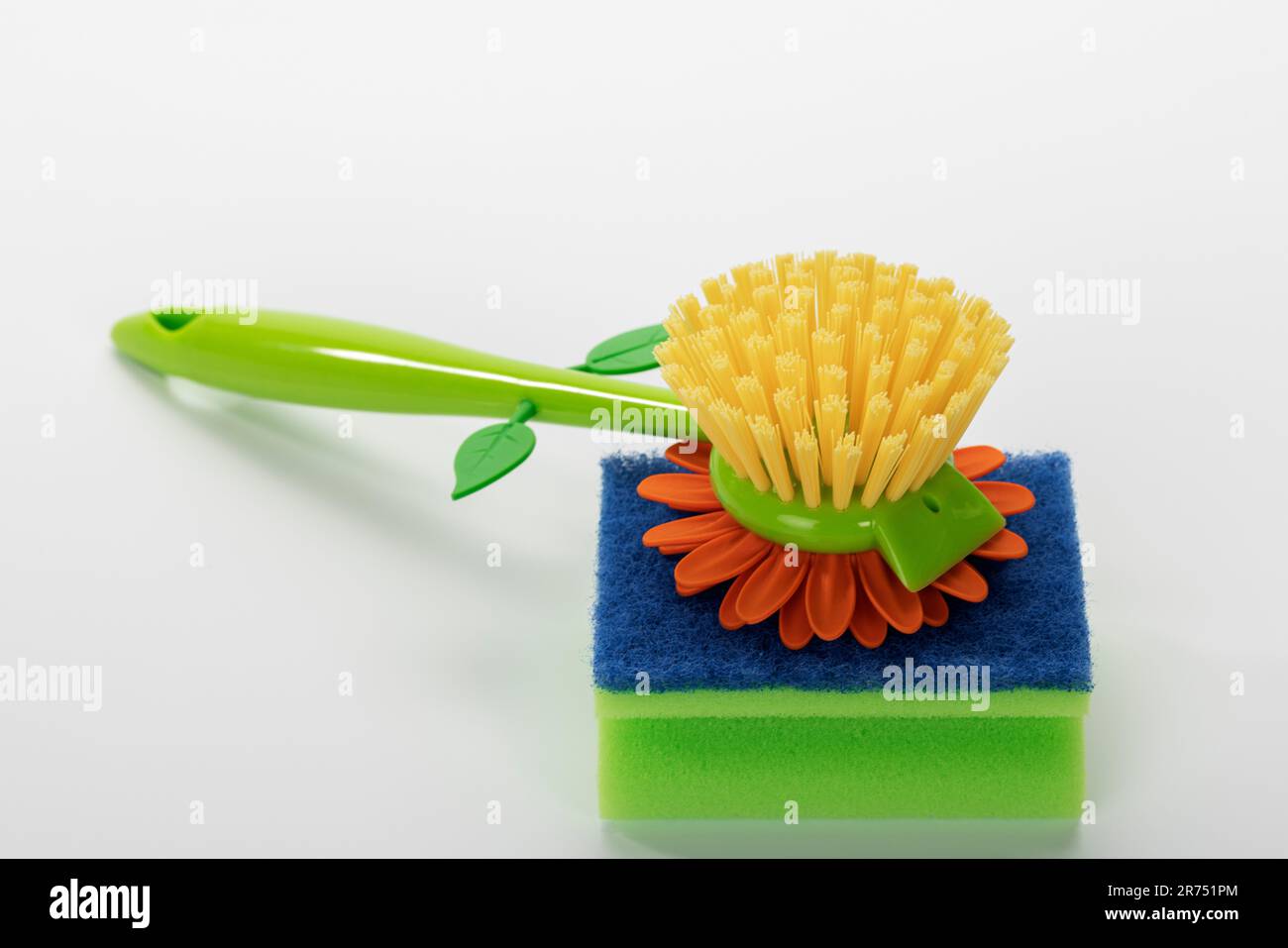 Decorative yellow dish brush flower-shaped from VIGAR 'Flower Power', cleaning sponge, white background, Stock Photo