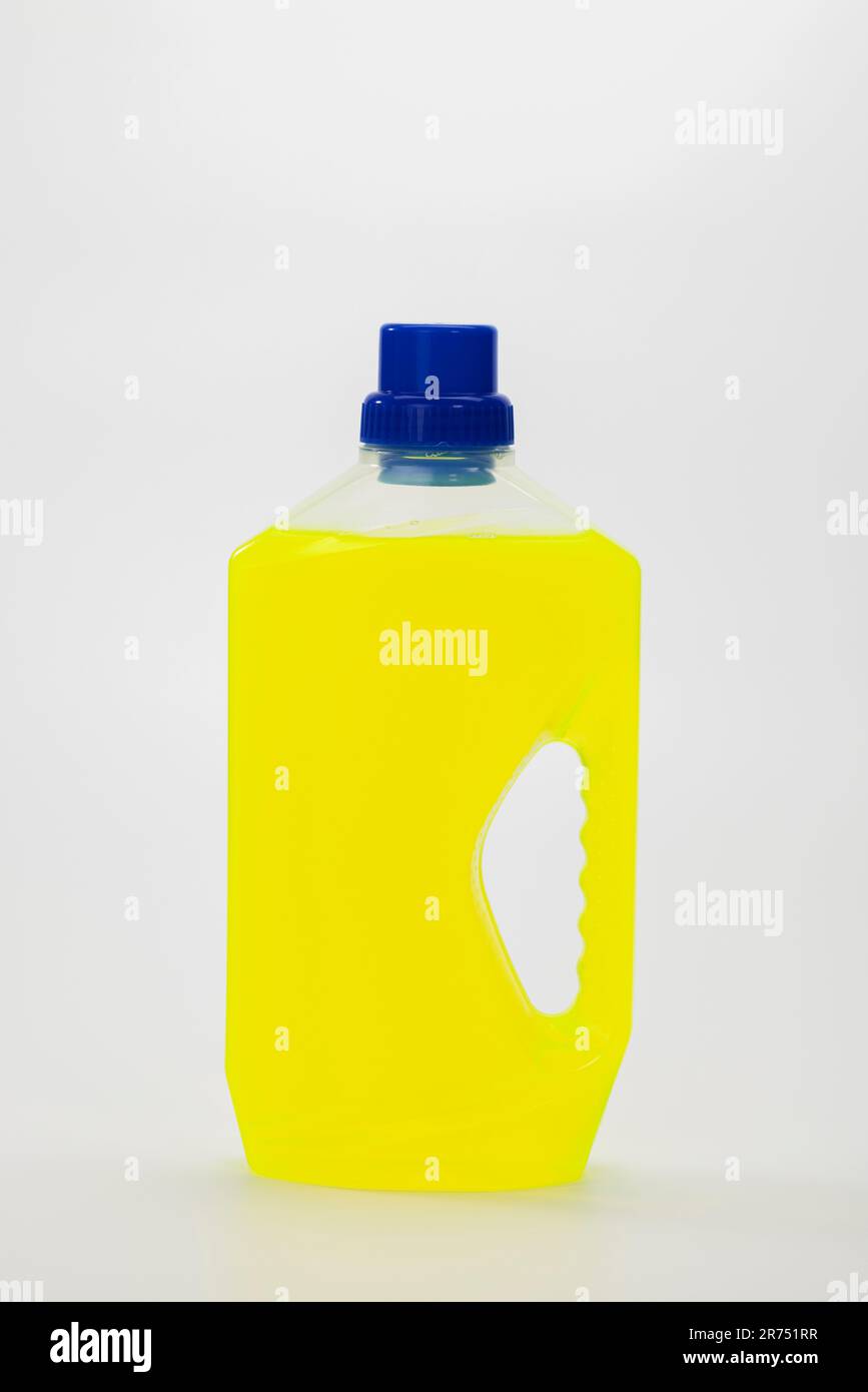 Plastic bottle, universal cleaner, yellow, white background Stock Photo
