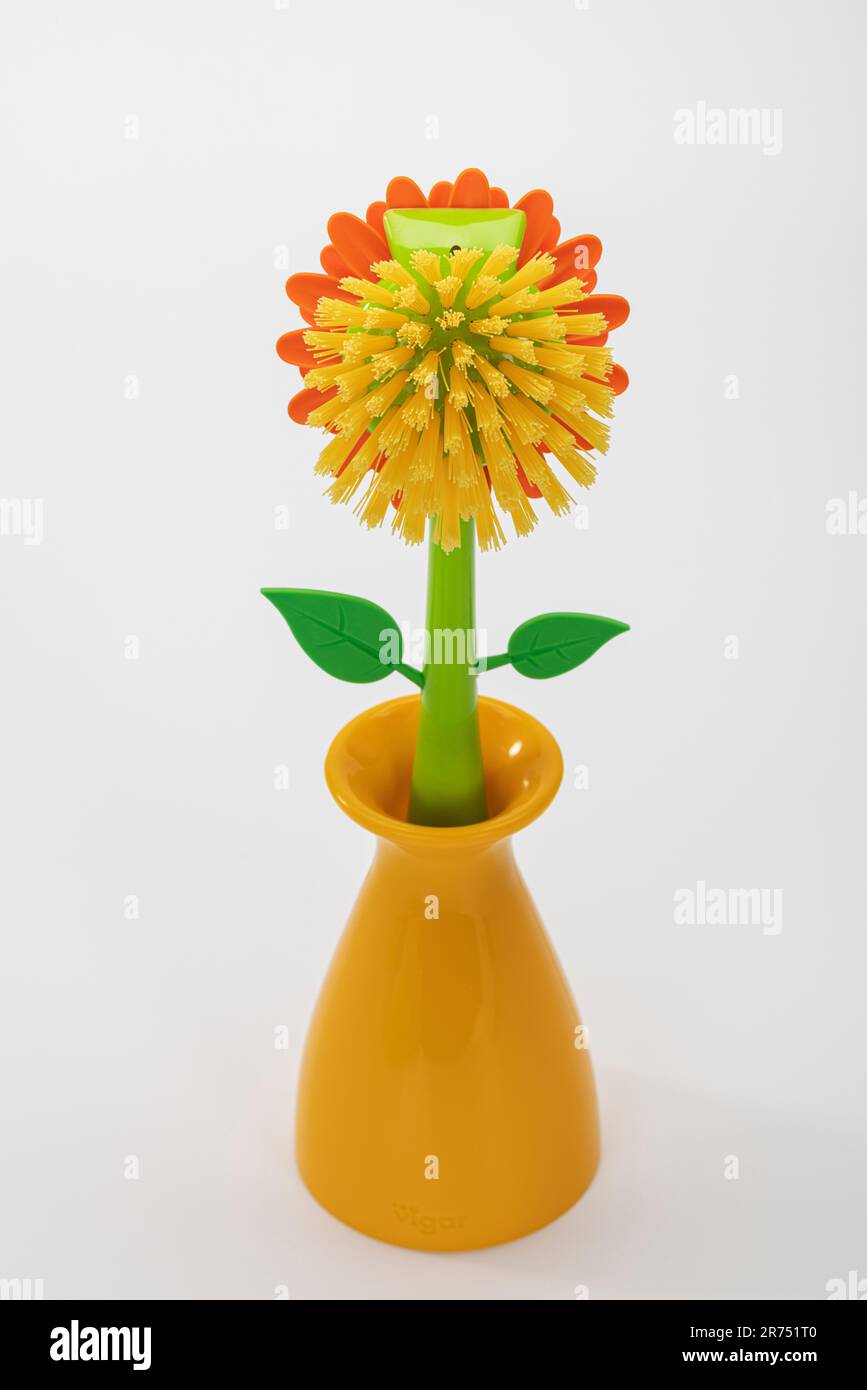 Decorative yellow dish brush flower shaped in vase by VIGAR 'Flower Power', white background, Stock Photo
