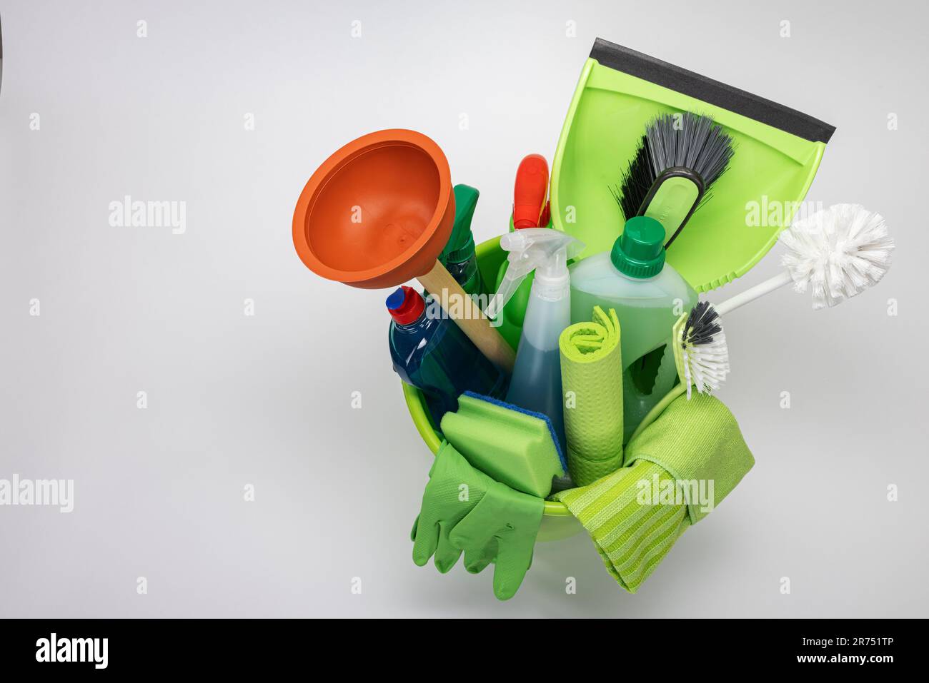 Green cleaning bucket filled with cleaning utensils, white background ...