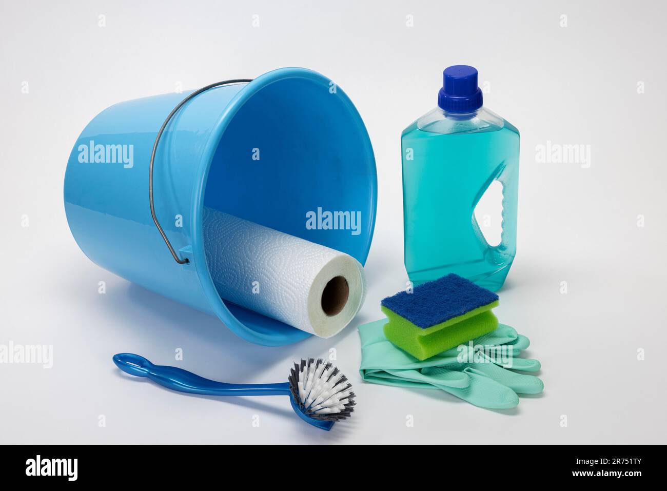 Blue cleaning bucket, brush, cleaning sponge, cleaning gloves, kitchen roll, all-purpose cleaner, white background, Stock Photo