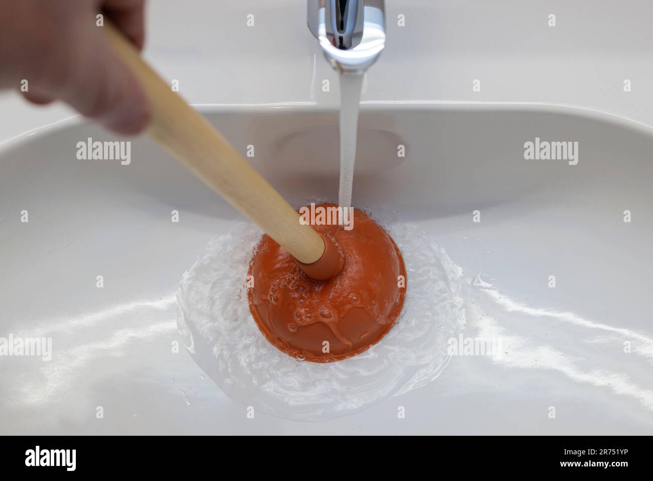 Sink, Clogged drain, unclog with the plunger, Stock Photo