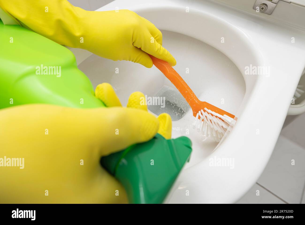 Clean toilet, clean toilet rim with rim cleaner and brush, detail Stock