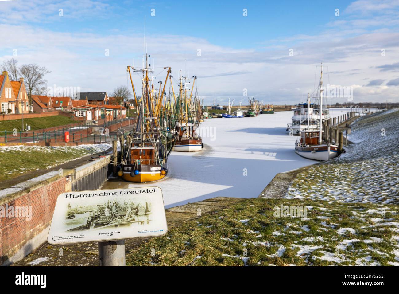 Winter atmosphere, icy harbor, sign, historical Greetsiel, fishing harbor of Greetsiel, Krummhörn, East Frisia, Lower Saxony, Stock Photo