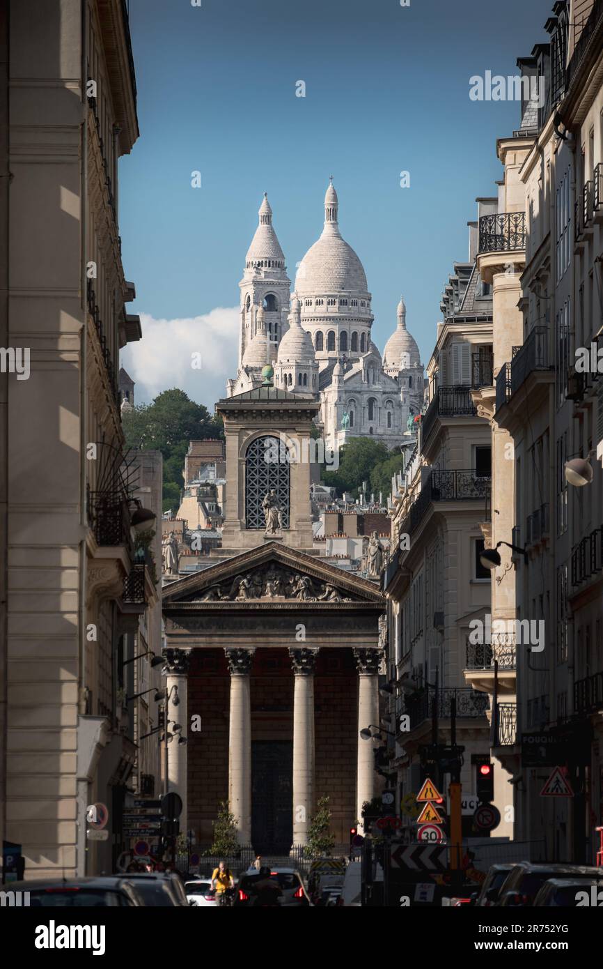 Basilica of Sacré Coeur de Montmartre with the Notre-Dame-de-Lorette from the street of Paris Stock Photo