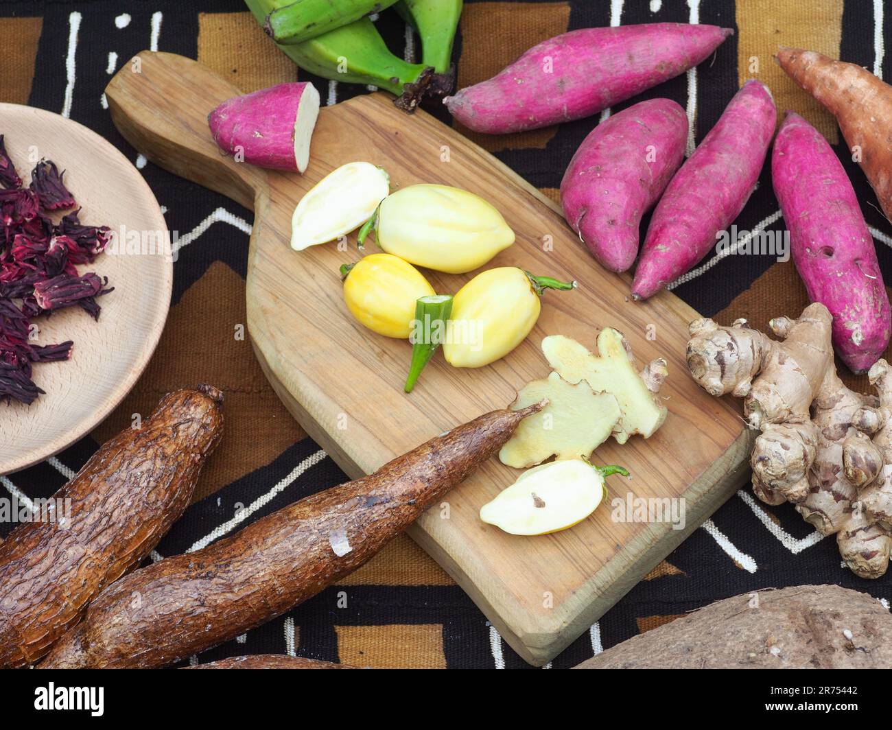 black woman cutting typical african veggies and fruits, overhead shot. Cooking Ivory coast local food. Stock Photo