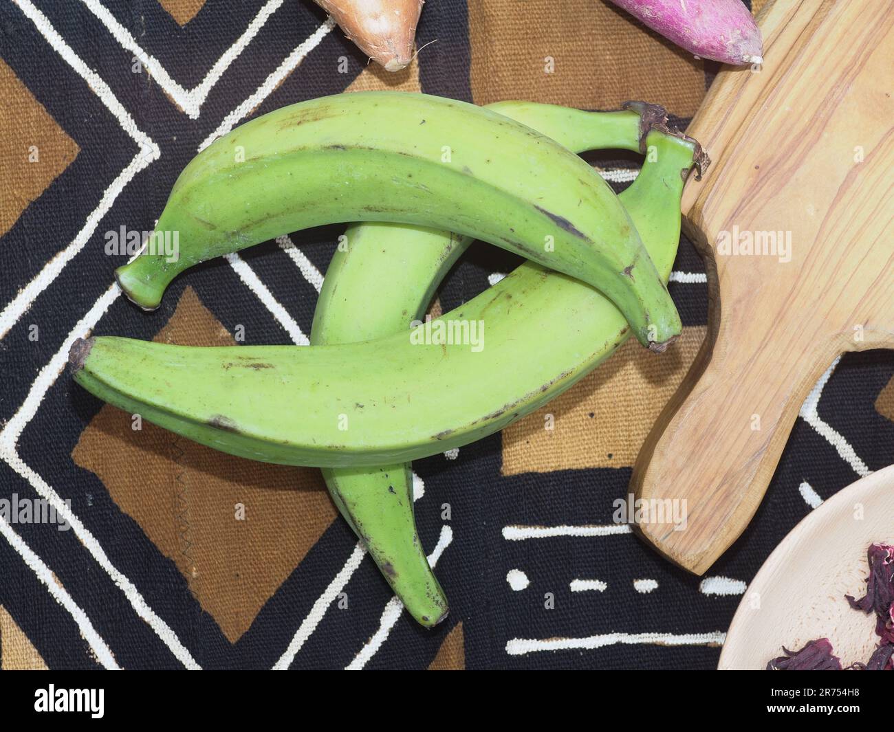 woman holding green ripe plantain as ingredient for african food Stock Photo