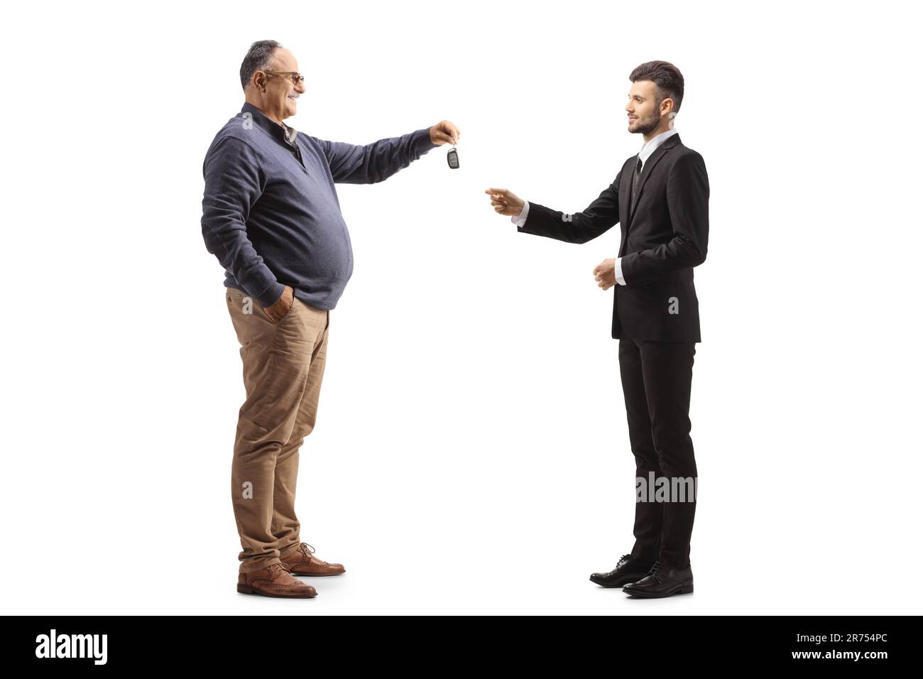 Mature man handing car keys to a valet isolated on white background Stock Photo