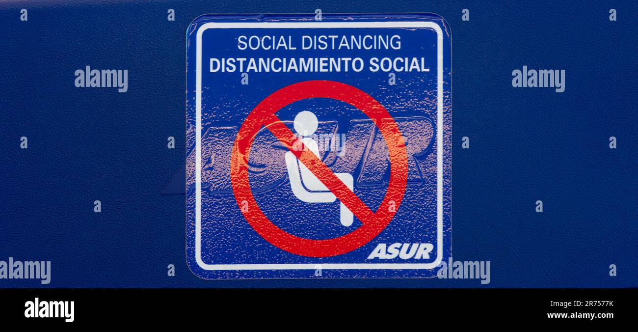 Social distancing sign in seating area, Covid restrictions, Merida airport, Mexico Stock Photo