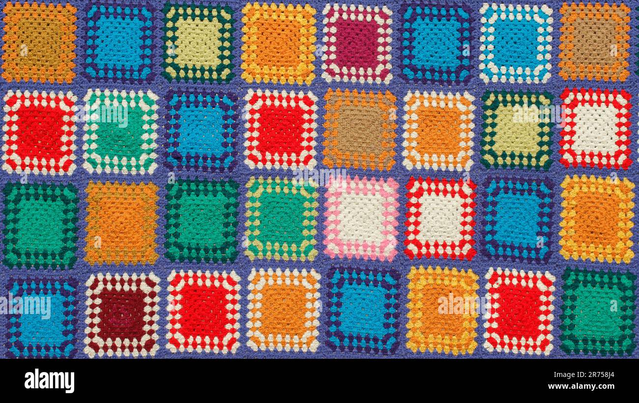 Detail of a crocheted patchwork multicolor wool blanket. Stock Photo
