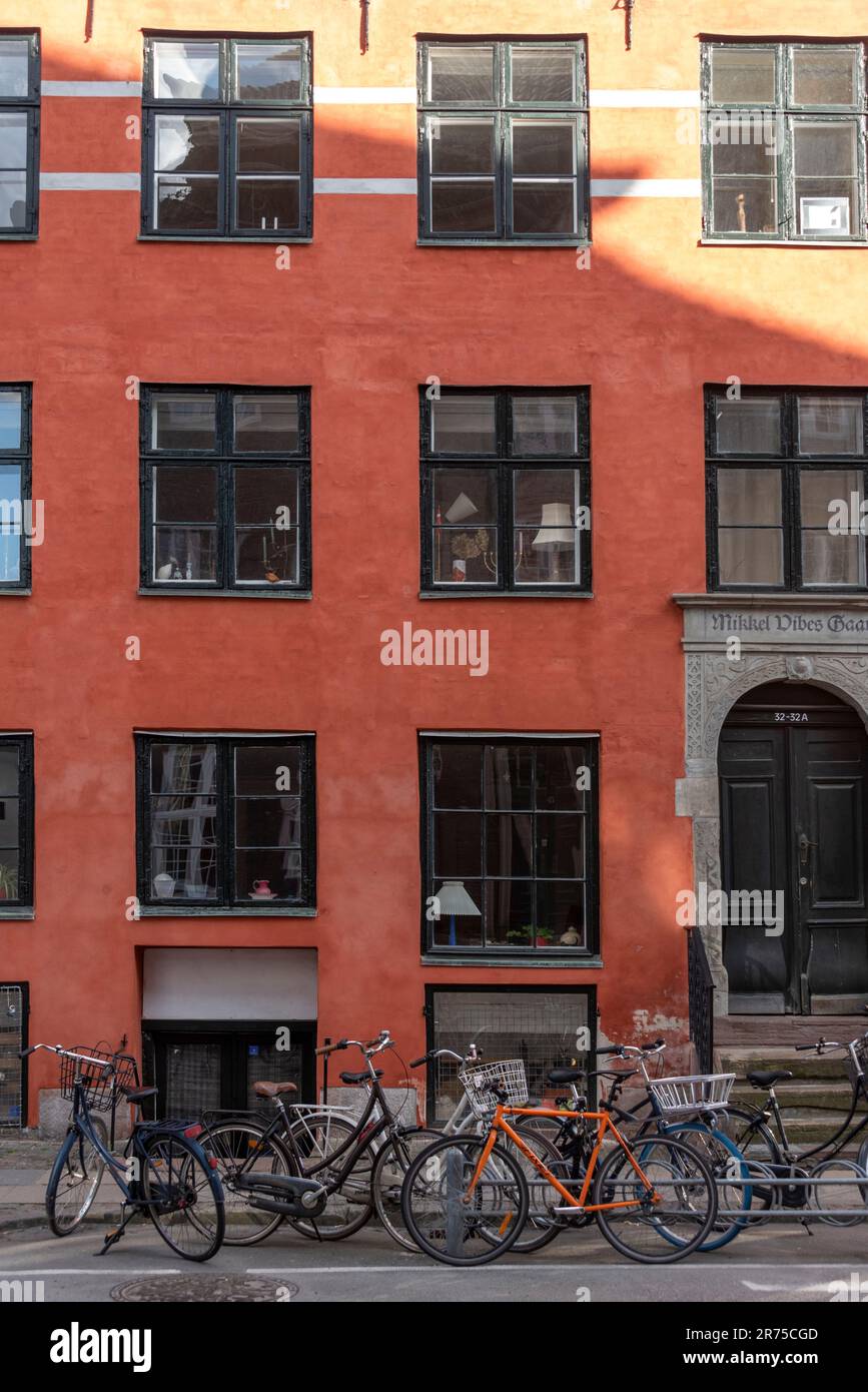 Bicycles, red apartment house, Copenhagen, Denmark Stock Photo