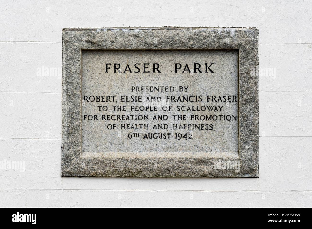 Stone plaque at entrance to Fraser Park, Scalloway on Shetland records the gift of the park by the Fraser family in 1942. Stock Photo