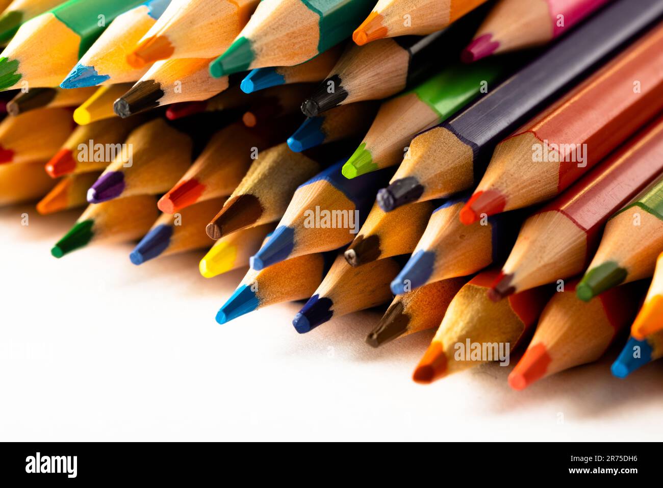 https://c8.alamy.com/comp/2R75DH6/close-up-of-multi-coloured-pencils-and-copy-space-on-white-background-writing-colouring-learning-school-and-education-concept-2R75DH6.jpg