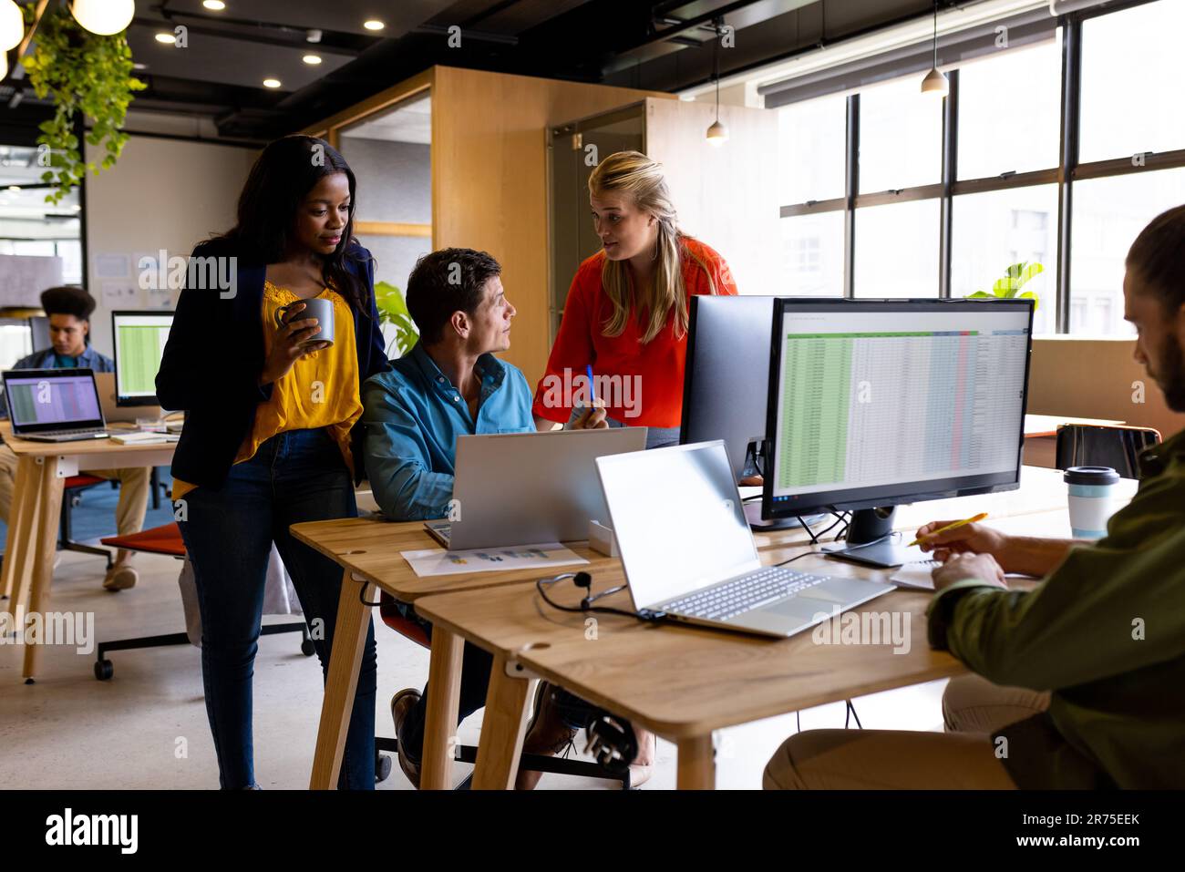 Diverse male female colleagues desk hi-res stock photography and images ...