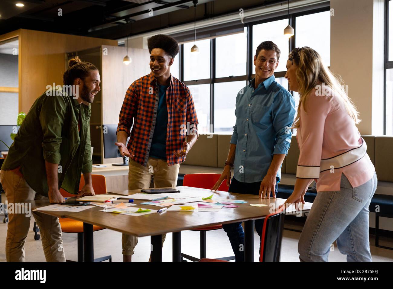 Happy diverse creative colleagues in discussion brainstorming using ...