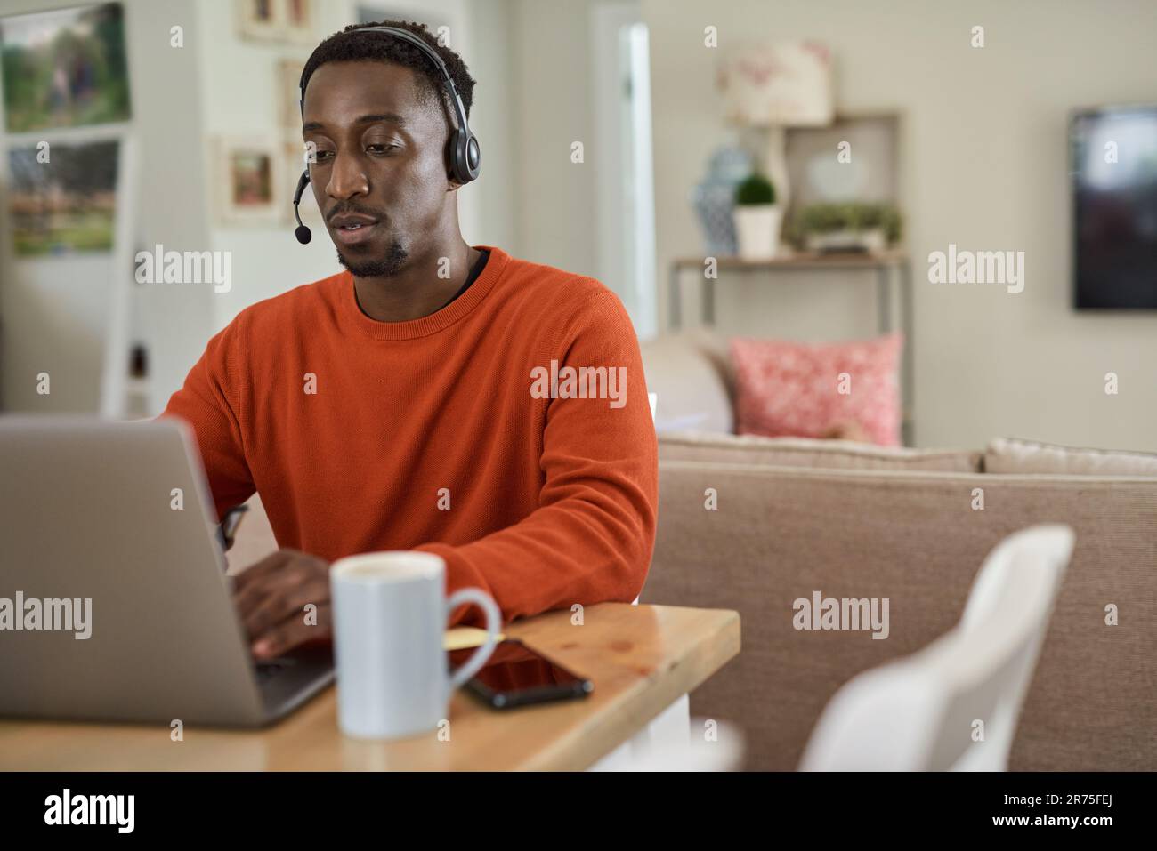 Businessman wearing a headset while working remotely from home Stock Photo