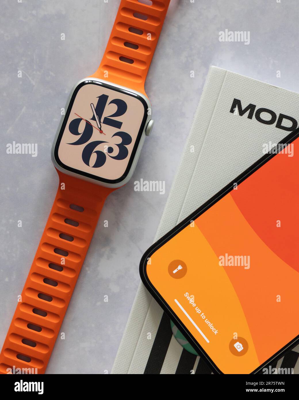 LONDON JUNE 7, 2023 Apple Watch with bright orange band strap and
