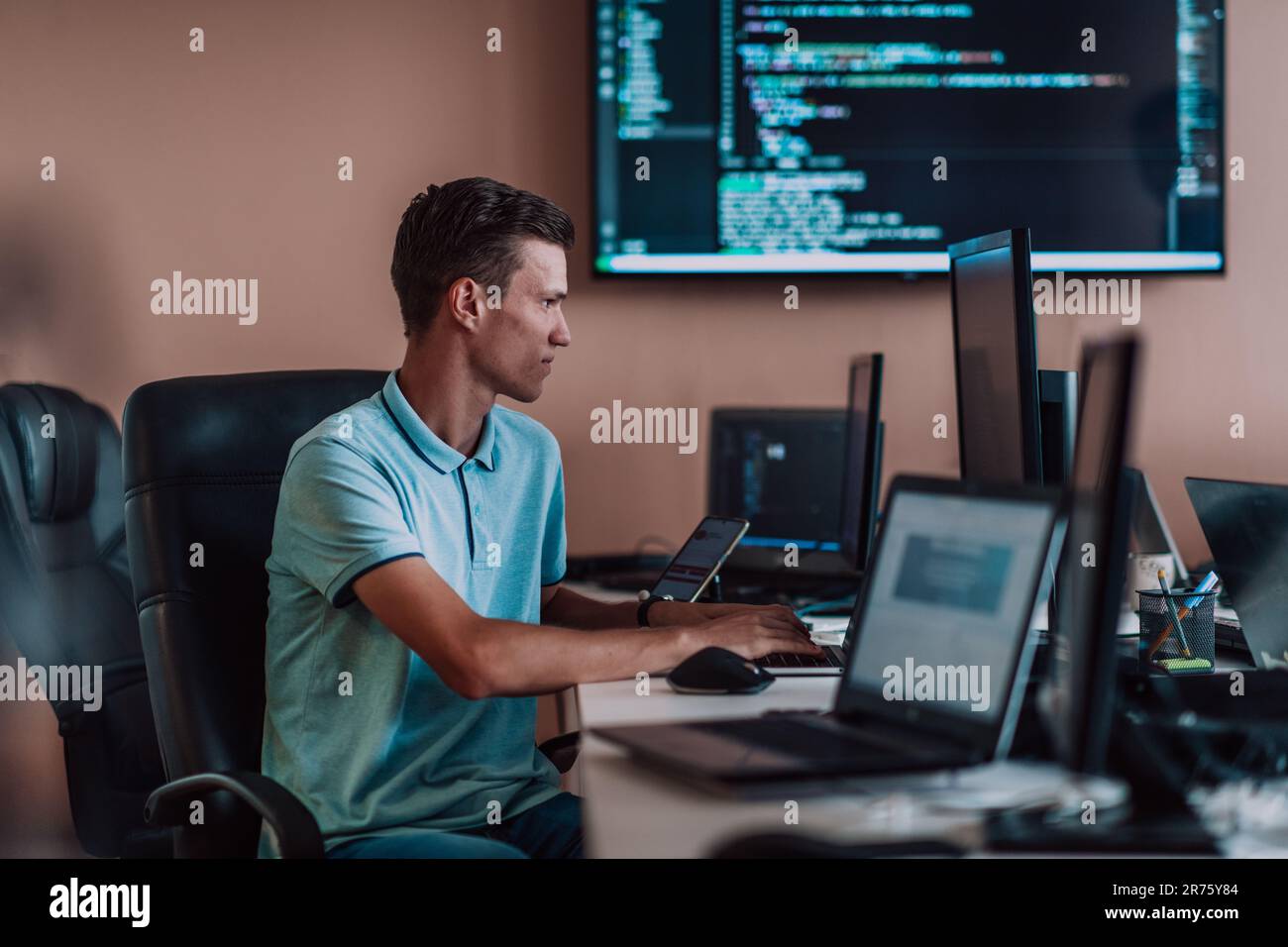 A programmer diligently testing smartphone applications while sitting ...