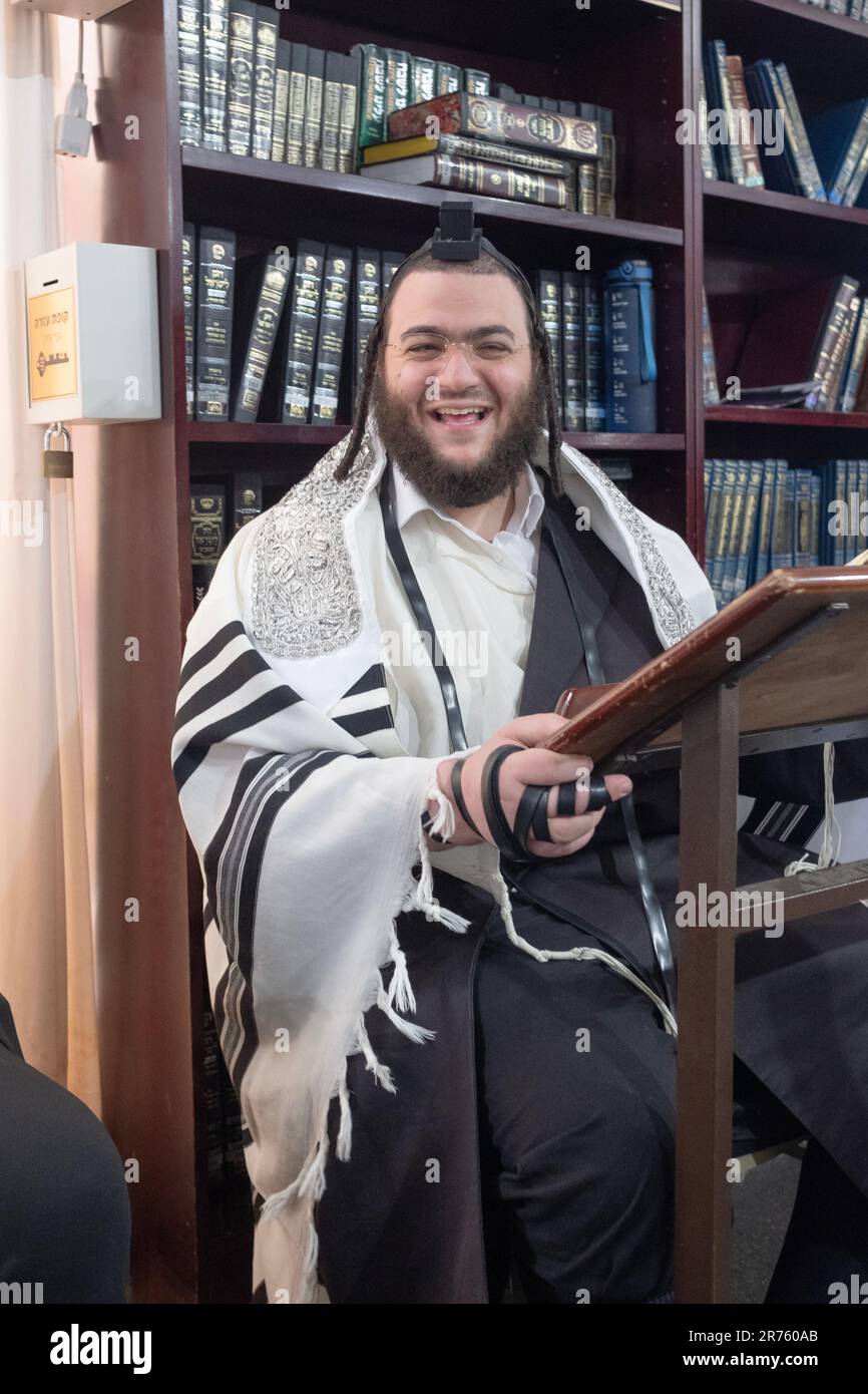 An orthodox Jewish man with a warm smile in a synagogue in Monsey
