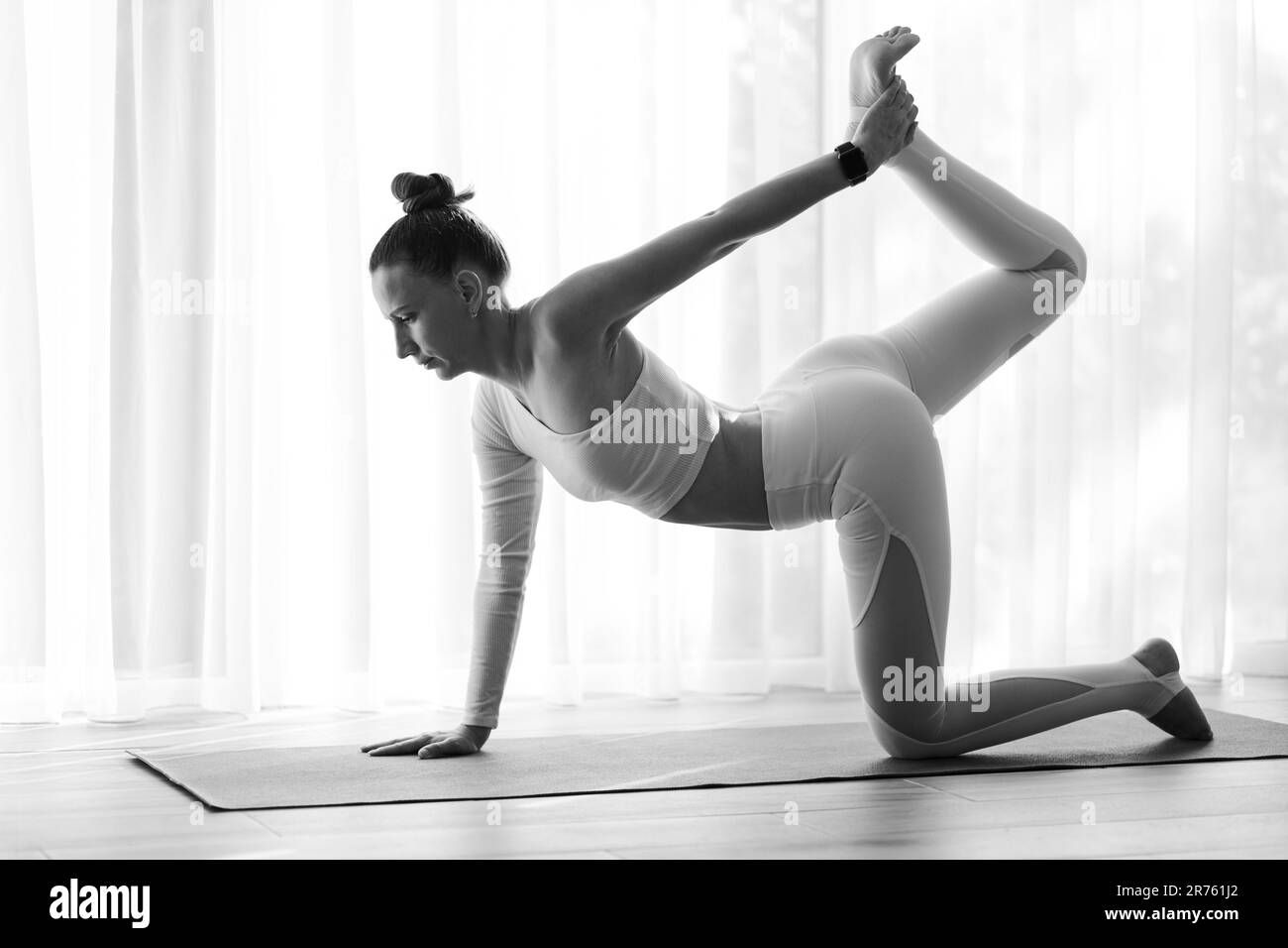 Young slim woman stretching legs and body in the morning training Stock Photo