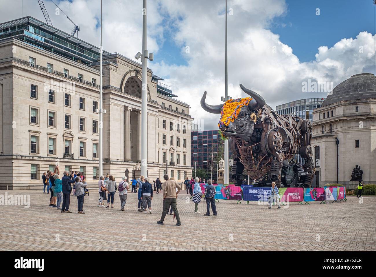 Tourists and sightseers taking photographs of the iconic giant metal bull that first appeared during the Birmingham Commonwealth games. Polinations. Stock Photo