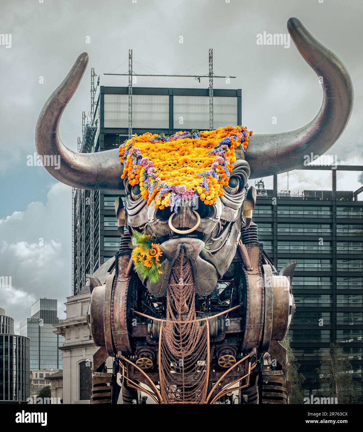 The iconic giant metal bull that was first seen at Birmingham Commonwealth games has its head covered with flowers during the Polinations event. Stock Photo