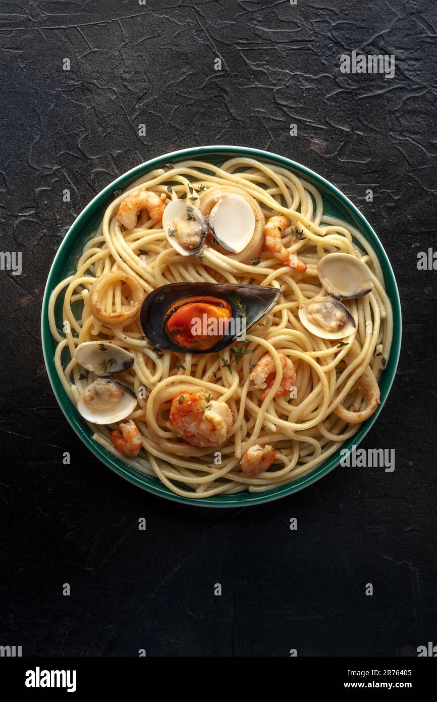 Seafood pasta, top shot. Spaghetti with mussels and calamari, shrimps and clams, with thyme