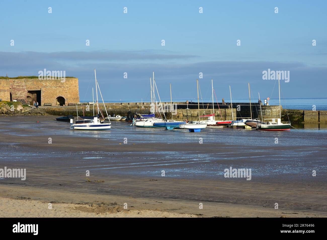 Beadnell Bay, boats outside the harbour, Northumberland Stock Photo
