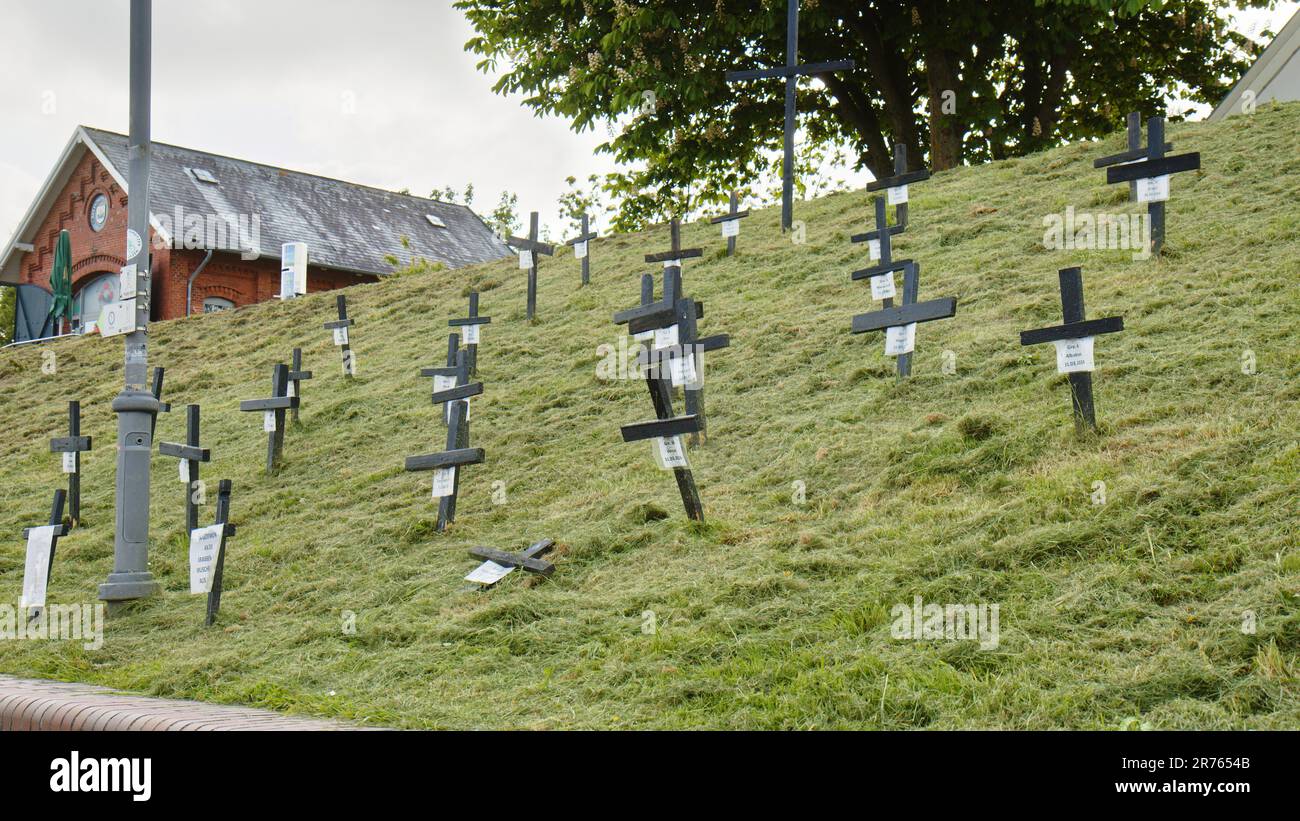 Black Crosses on a Dike in the Harbor of Greetsiel as a silent protest by the fishermen against a planned ban of bottom trawls Stock Photo