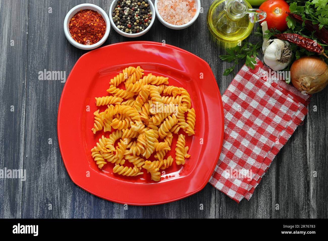 Fusilli pasta in tomato sauce. gray background. Italian food concept Stock Photo