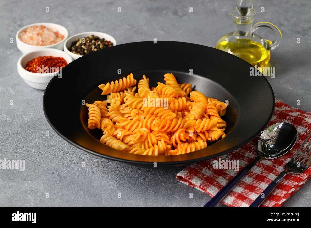 Fusilli pasta in tomato sauce. gray background. Italian food concept Stock Photo