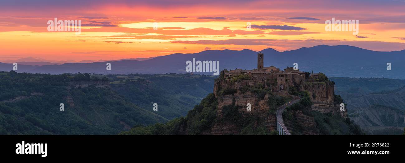 A wide 3:1 panorama photo from a sunrise at the Civita di Bagnoregio, a remote village in the municipality of Bagnoregio in the province of Viterbo, L Stock Photo