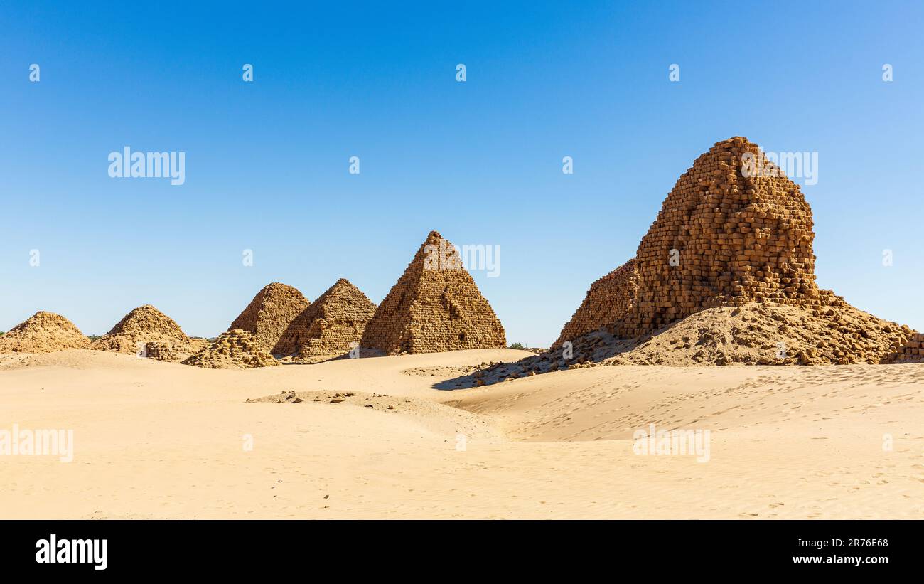 the nubian pyramids of the black pharoahs of the napata kingdom of sudan are lined up on a ridge weatherbeaten and crumbling into the desert Stock Photo