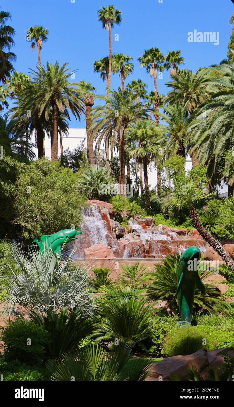 Waterfall and dolphin sculptures in gardens at the entrance to The Mirage hotel and casino Las Vegas Strip Paradise Las Vegas Nevada USA Stock Photo