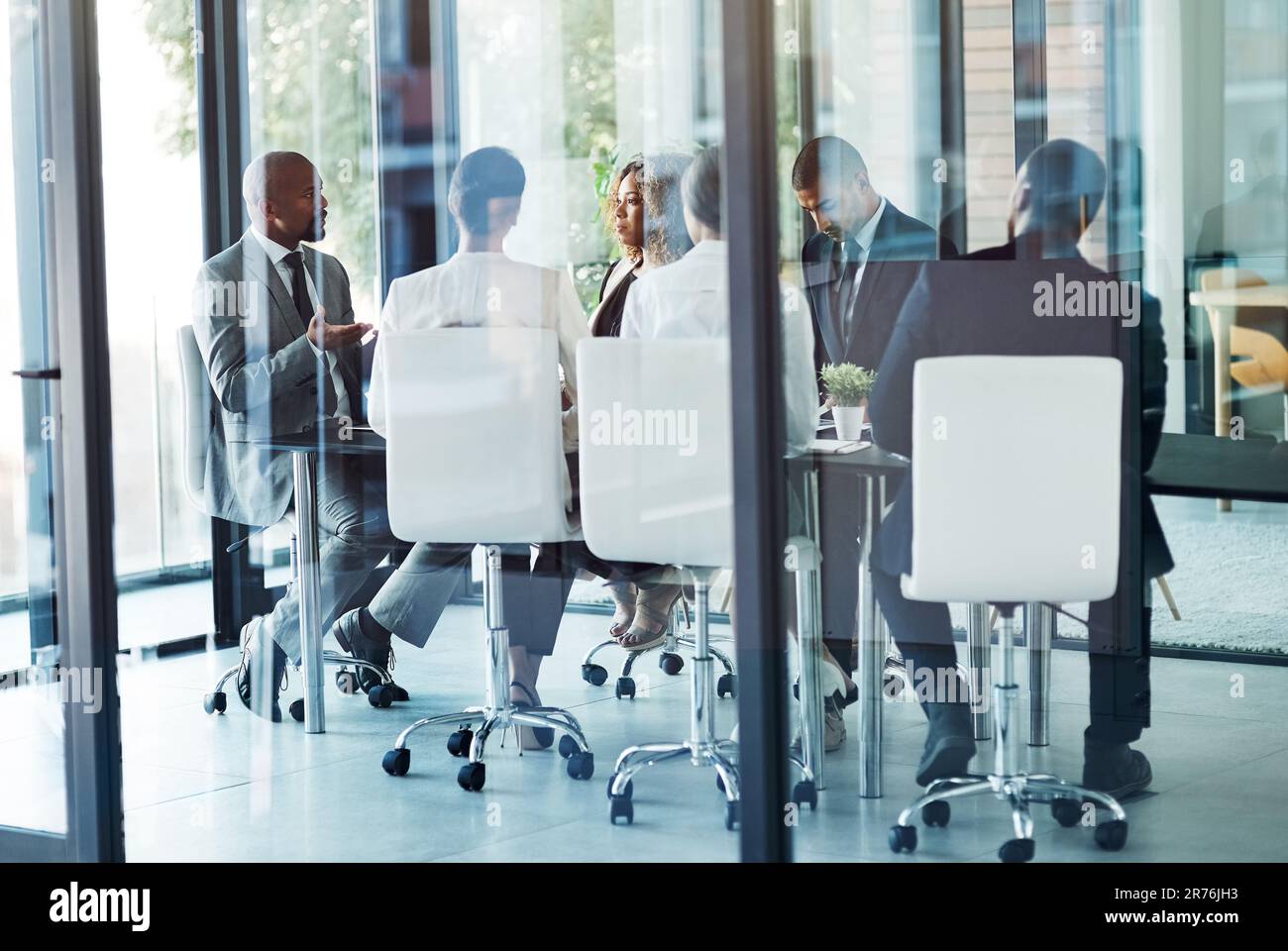 Effective facilitation makes for an effective meeting. a team of professionals having a meeting in the boardroom at work. Stock Photo