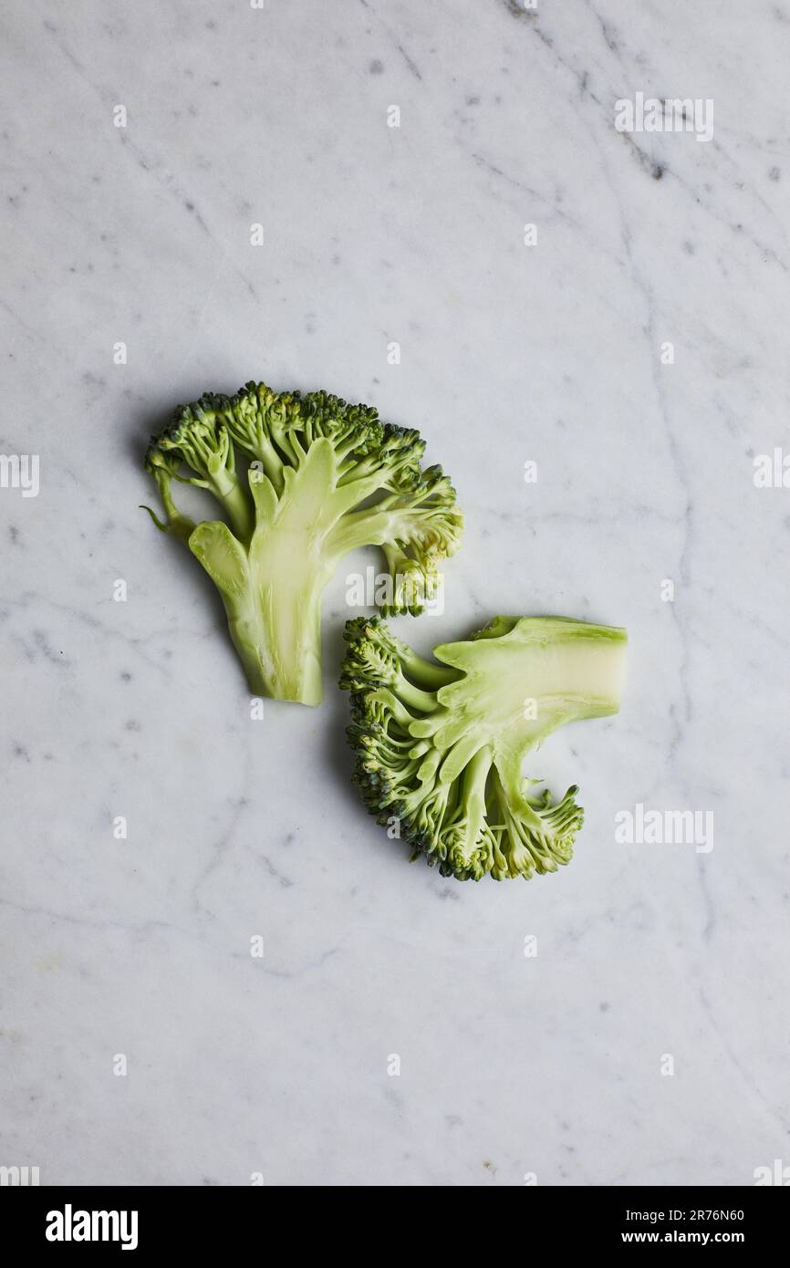 From above green broccoli stems placed on gray background Stock Photo