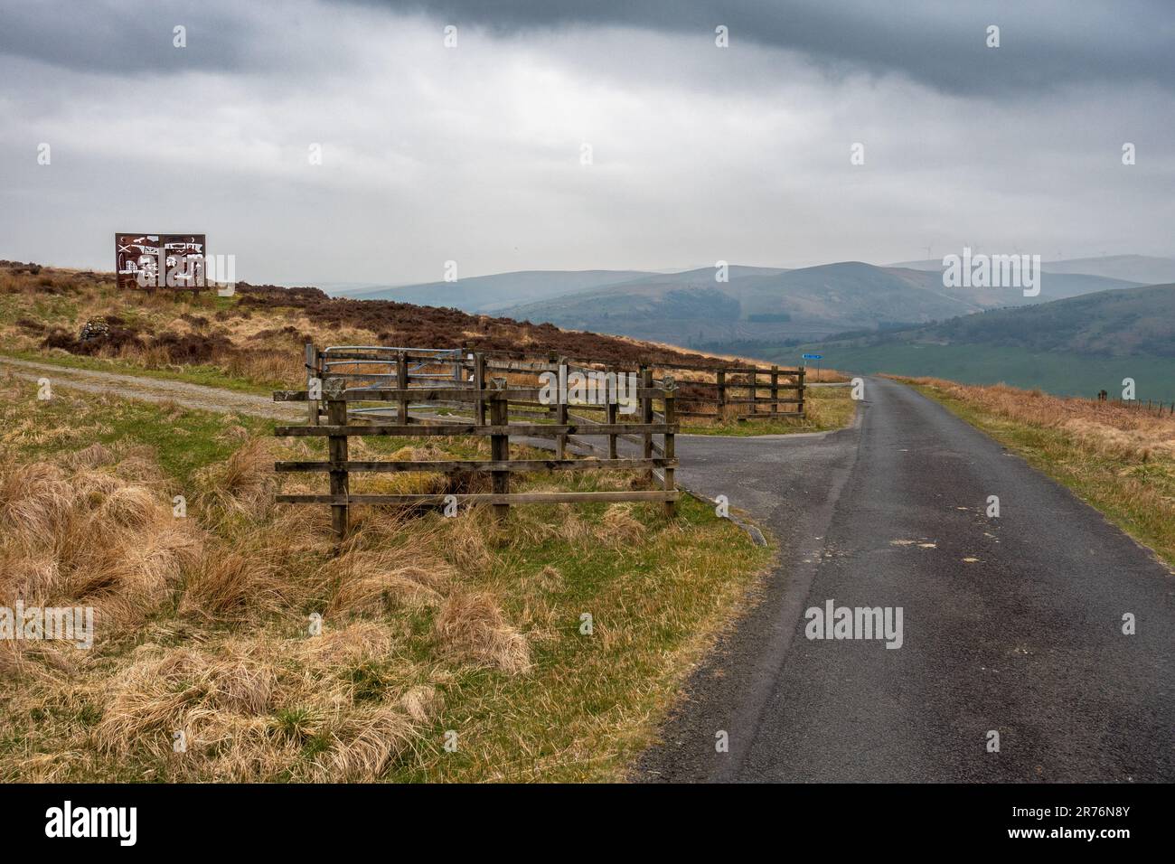 Single track road on the way to Langholm with the MacDiarmid Memorial on the hill on the left. Dumfries & Galloway, Scotland, UK Stock Photo
