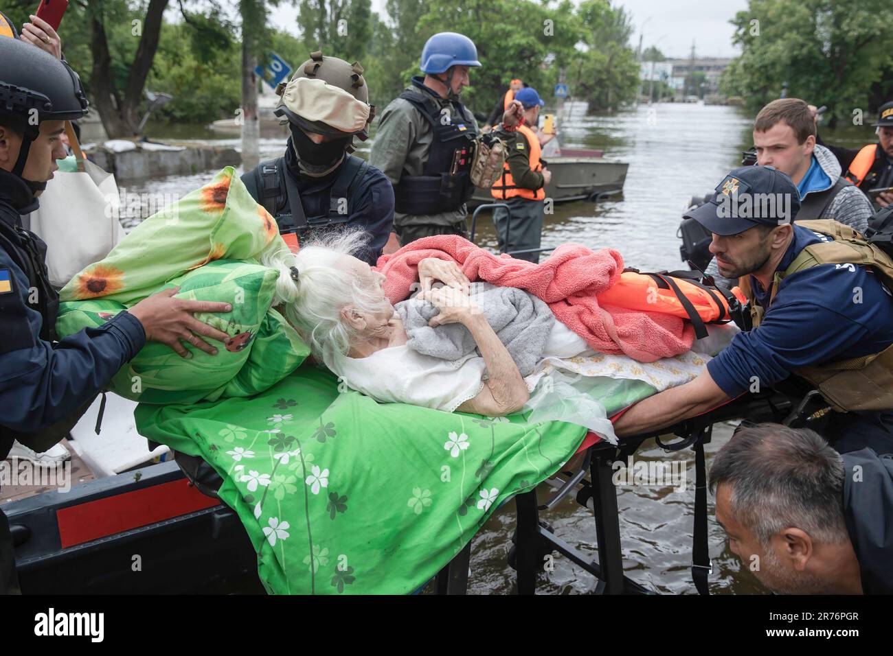 Lifeguards and volunteers seen evacuating an old person from a flooded(00)