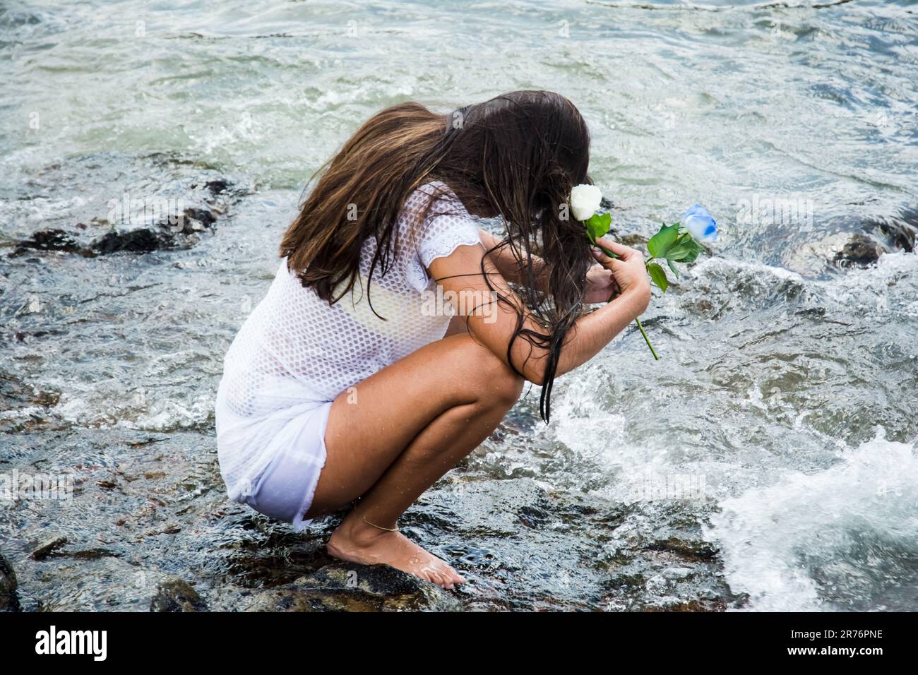 Woman kneeling on beach sunset hi-res stock photography and images - Alamy