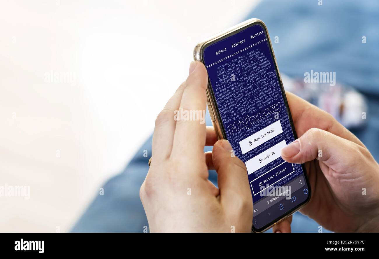 San Francisco, US, june 2023: Female hands holding a phone with the Midjourney website on the screen.Text-to-image AI program. Technology concept. Ill Stock Photo