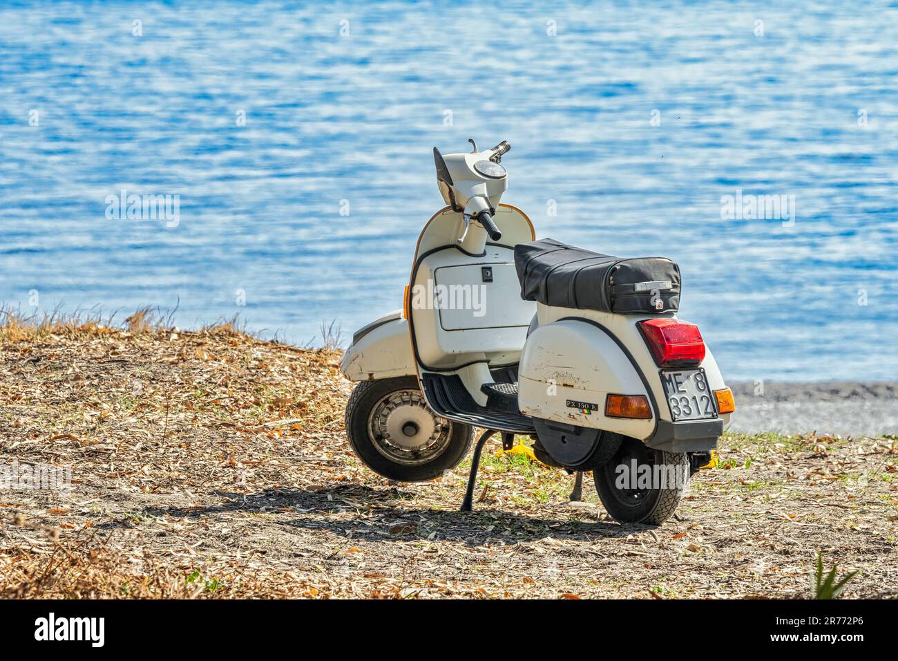 At the sea with the Vespa Piaggio PX 150 E, holidays by the sea in Sicily on the beach of San Marco di Calatabiano. Province of Messina, Sicily, Italy Stock Photo