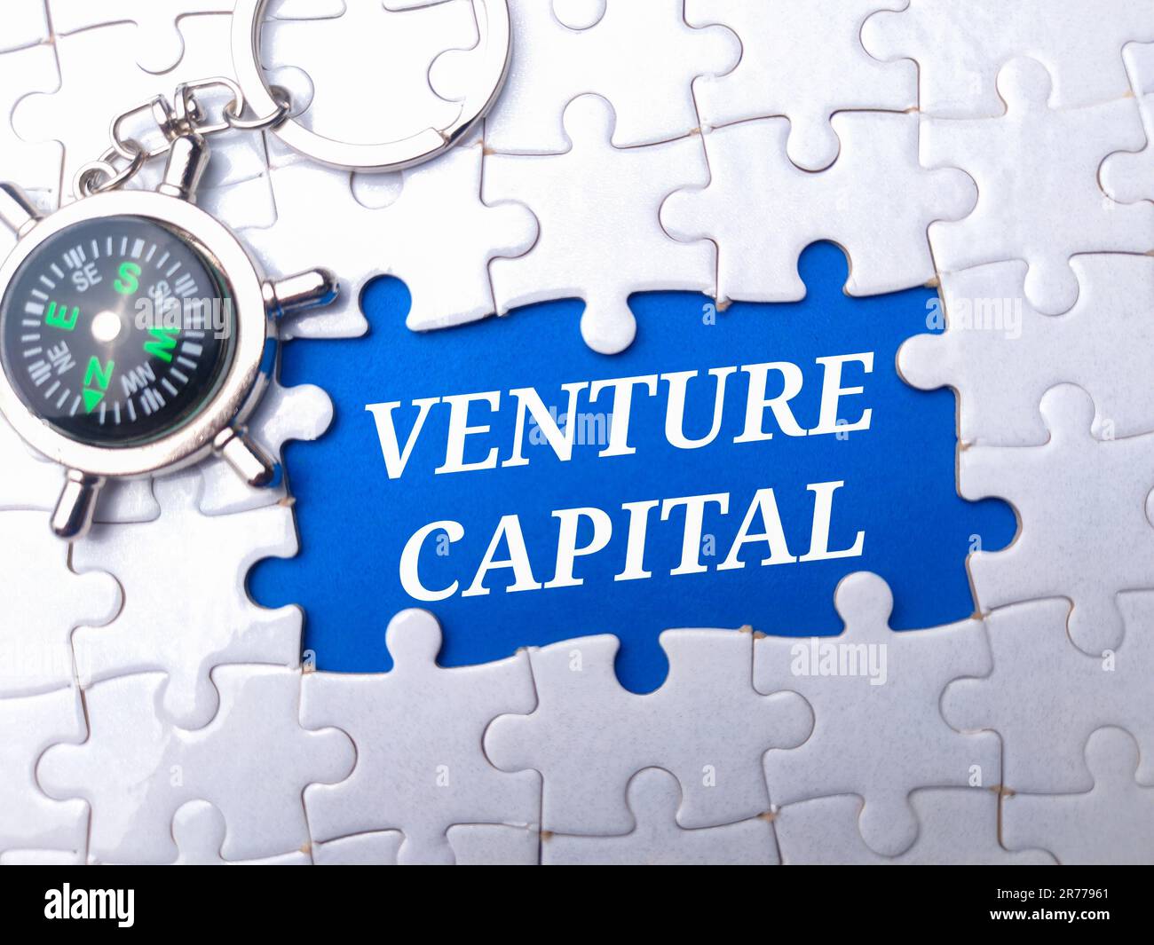A background with puzzle pieces and the words 'Venture Capital' written ...
